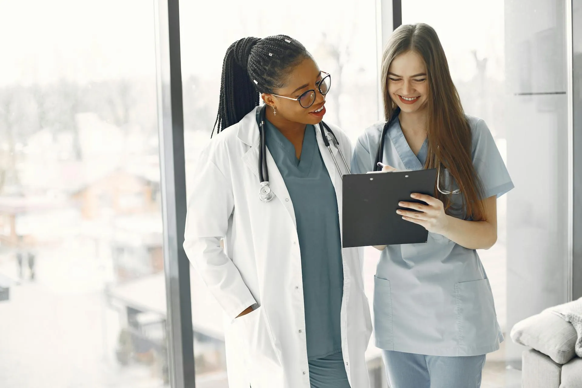 Two healthcare professionals reviewing patient documents together in a Taiwan clinic